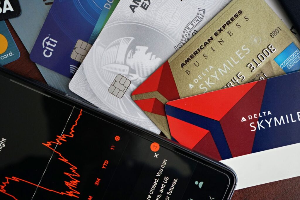 Home Image showing credit cards and a financial market graph on a smartphone.